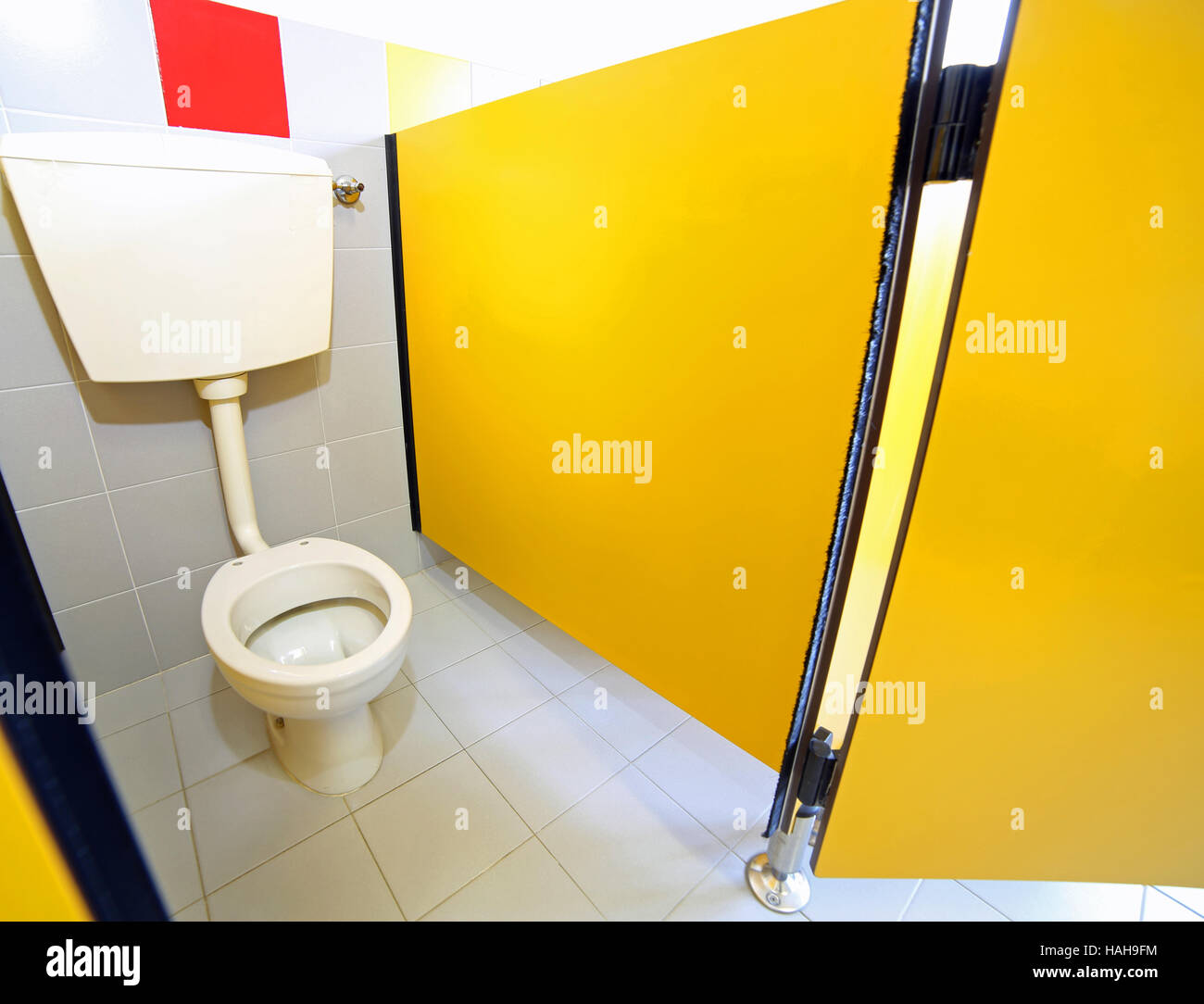 small toilet without toilet paper roll in the bathroom of a ...