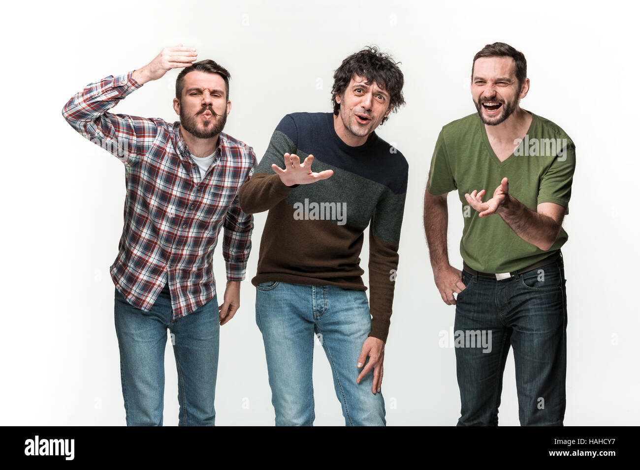 The three men are smiling, looking at camera Stock Photo - Alamy