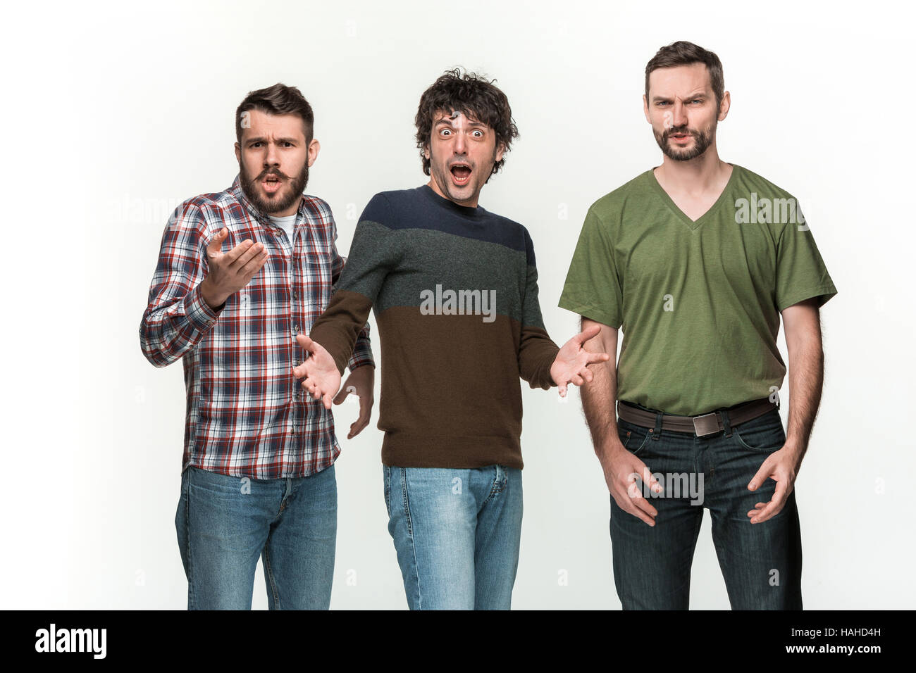 The three men are smiling, looking at camera Stock Photo - Alamy