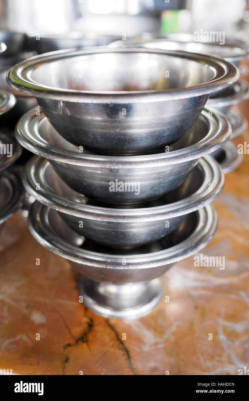Stack of small stainless bowls often used to serve desserts in Indian and Asian cuisine Stock Photo
