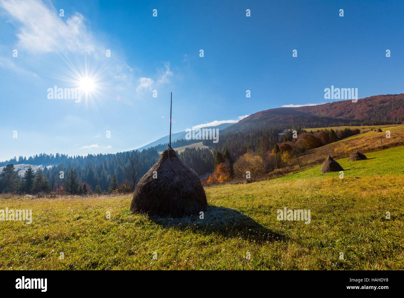Amazing rural scene on autumn valley. Haystack on a foreground. Carpathians, Ukraine, Europe. Stock Photo