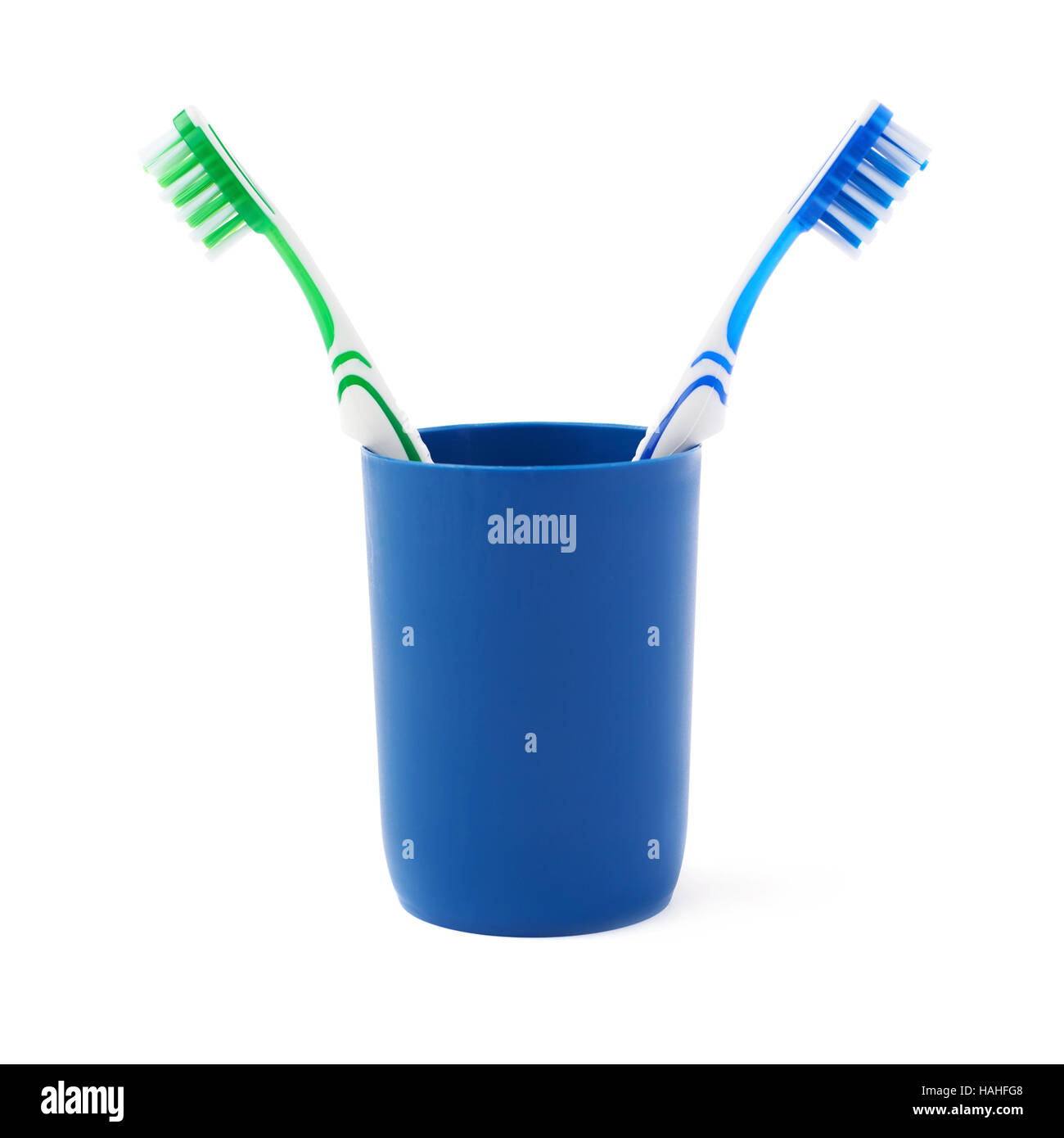 Pair of toothbrushes in blue plastic cup isolated over white background