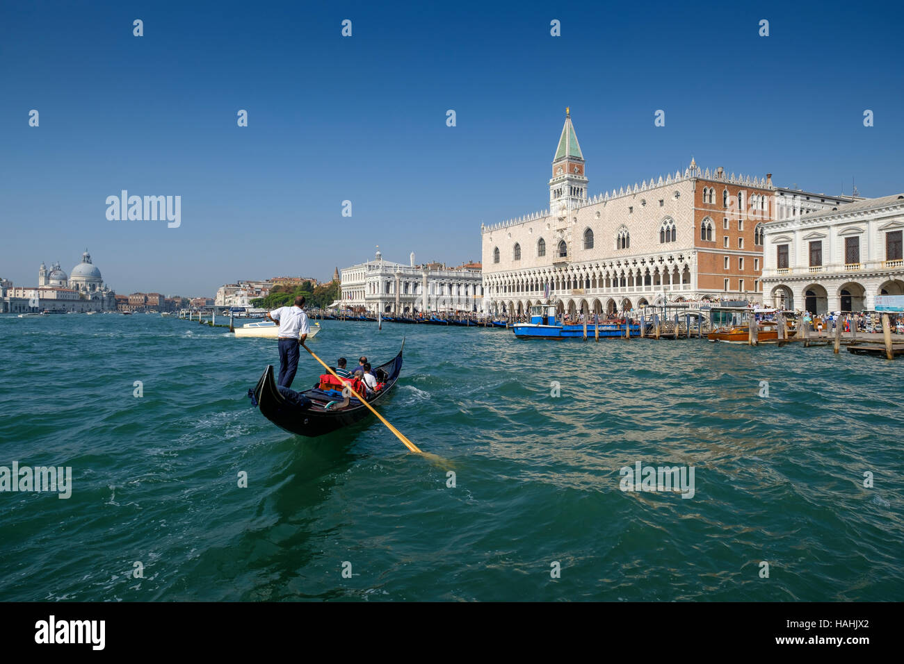 Doge's Palace and entrance to Piazza San Marco, St Mark's Square, from Grand Canal with gondola in foreground. Venice Italy Stock Photo