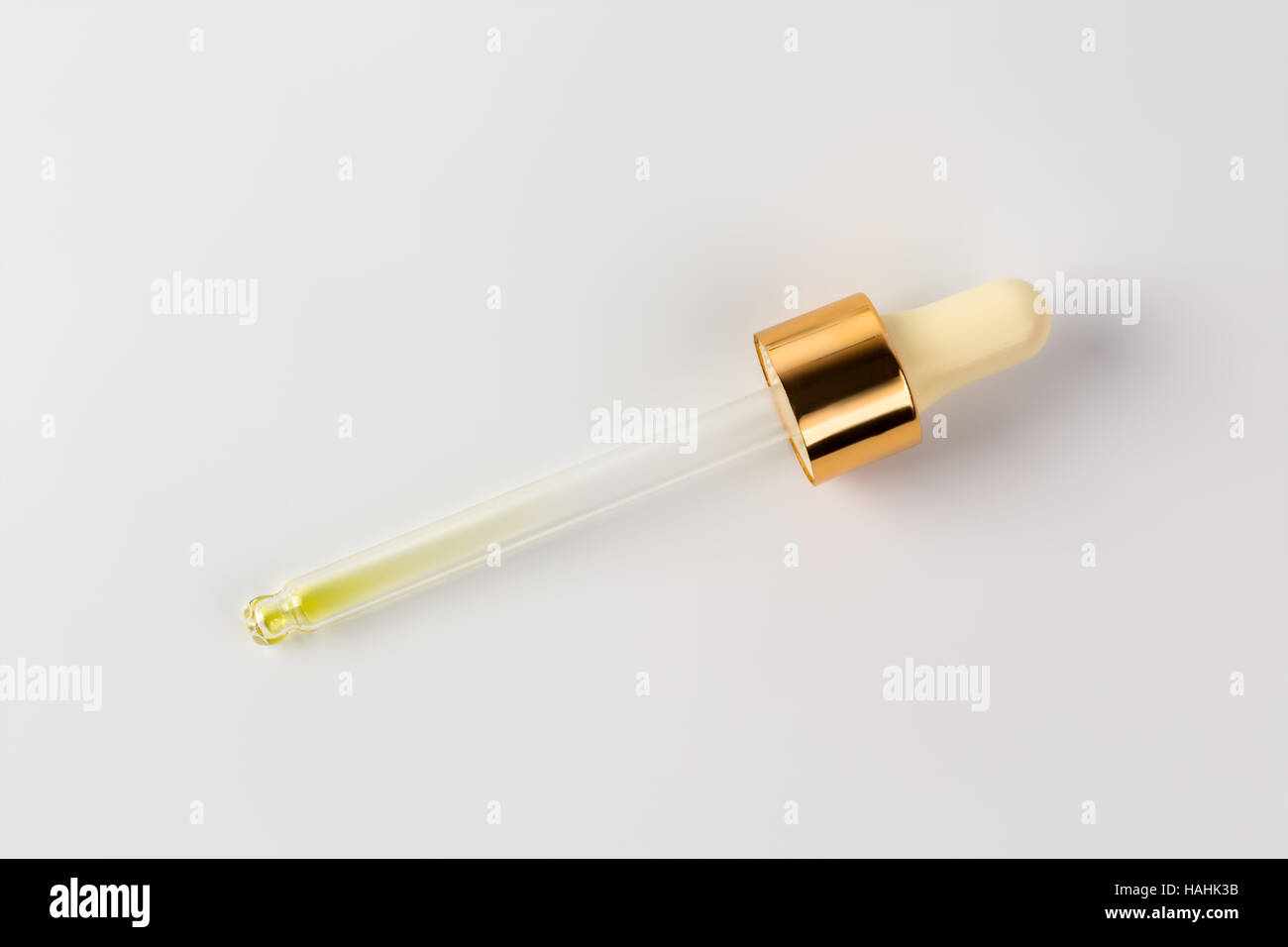 Essential oil or serum in pipette, white background Stock Photo