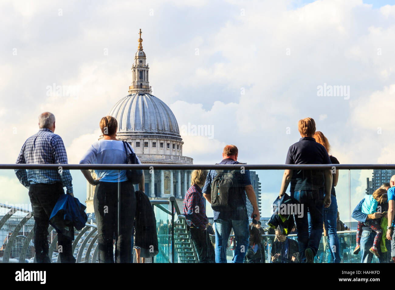 Sightseers on the Millennium Bridge looking at St. Paul's Cathedral, Bankside, London, UK Stock Photo