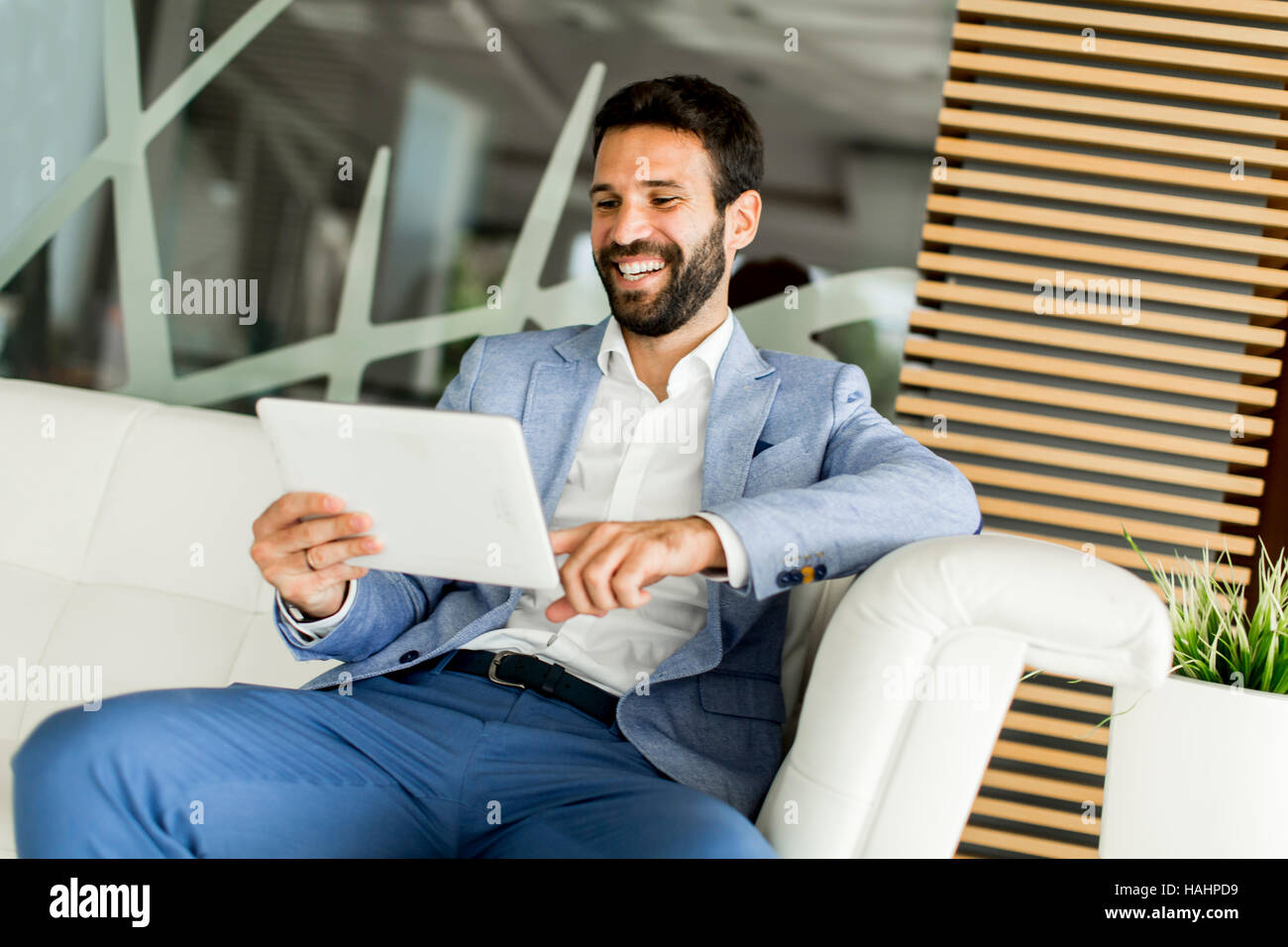 Businessman using his digital tablet at the office Stock Photo - Alamy