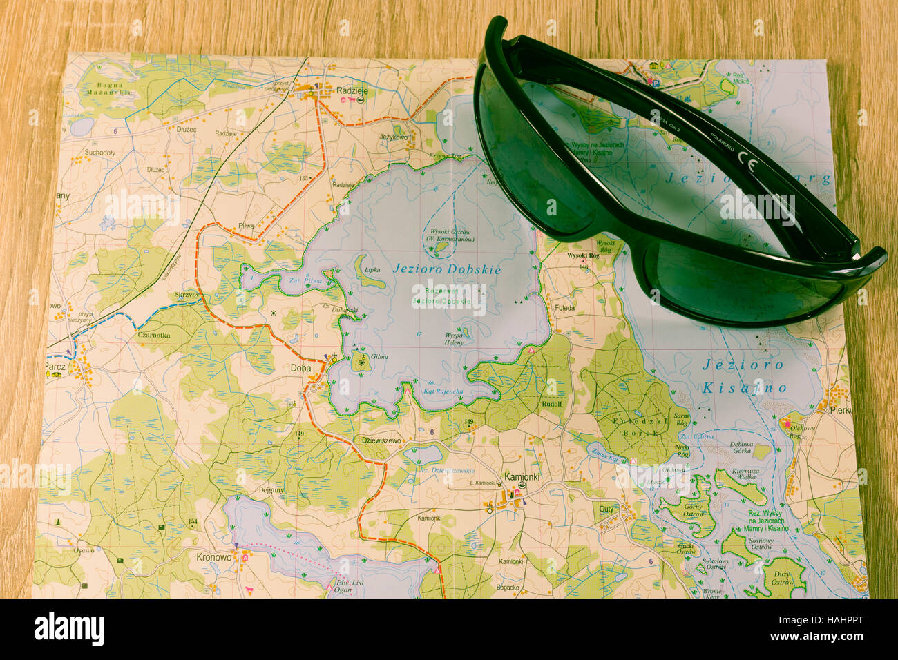 Eyewear placed on the map. Sunglasses with a map of specific Polish region. Glasses and map on a table Stock Photo