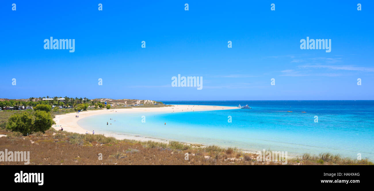 The sweeping curve of  the beach and crystal clear water at Coral Bay , Western Australia Stock Photo