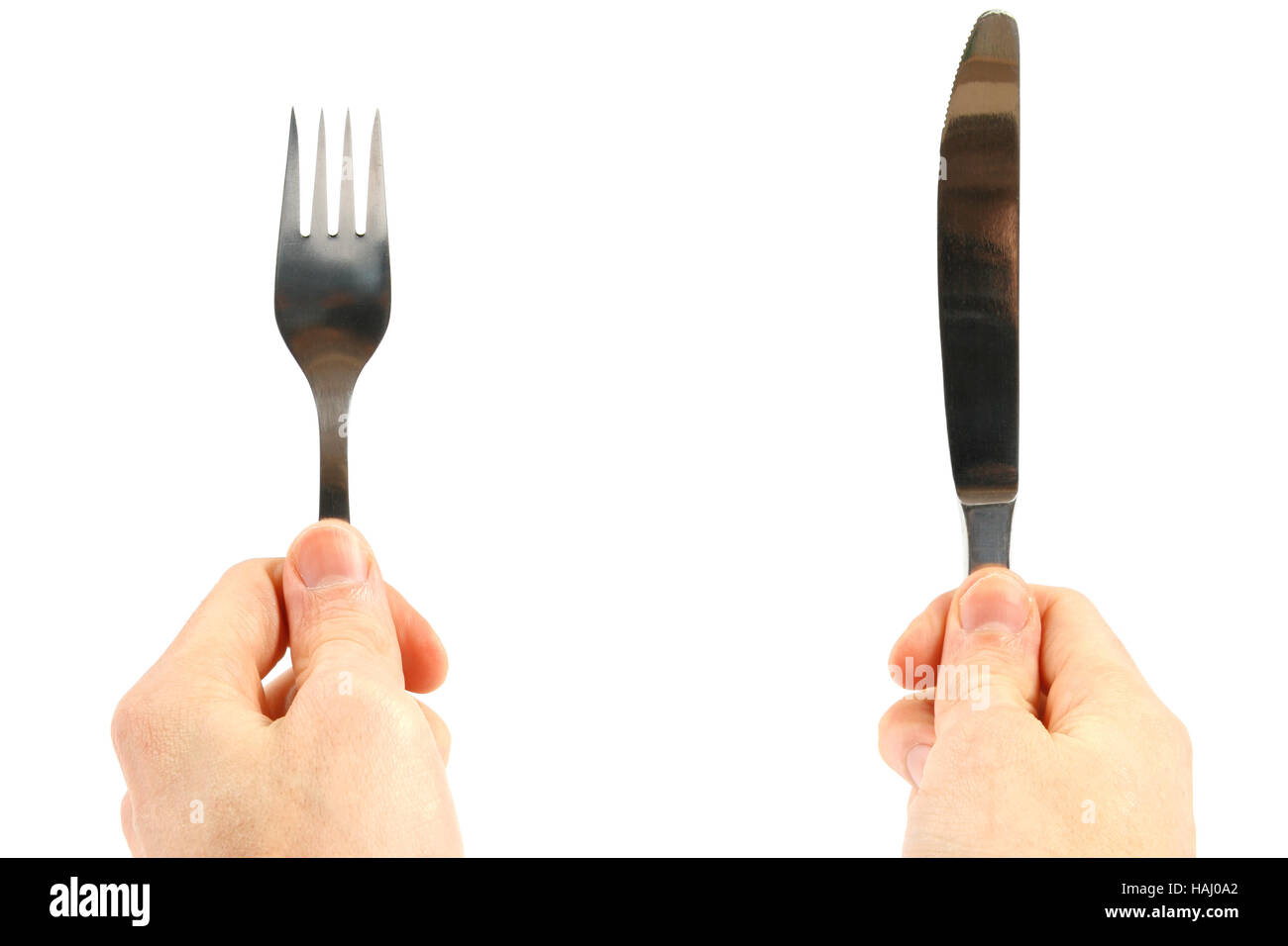Knife and fork in hands isolated on white background Stock Photo