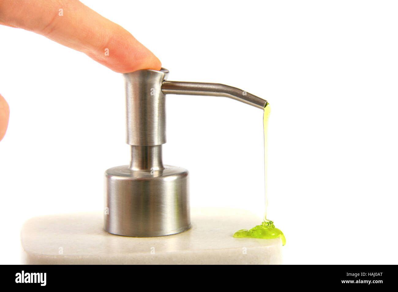 Finger pushing liquid soap pump Stock Photo