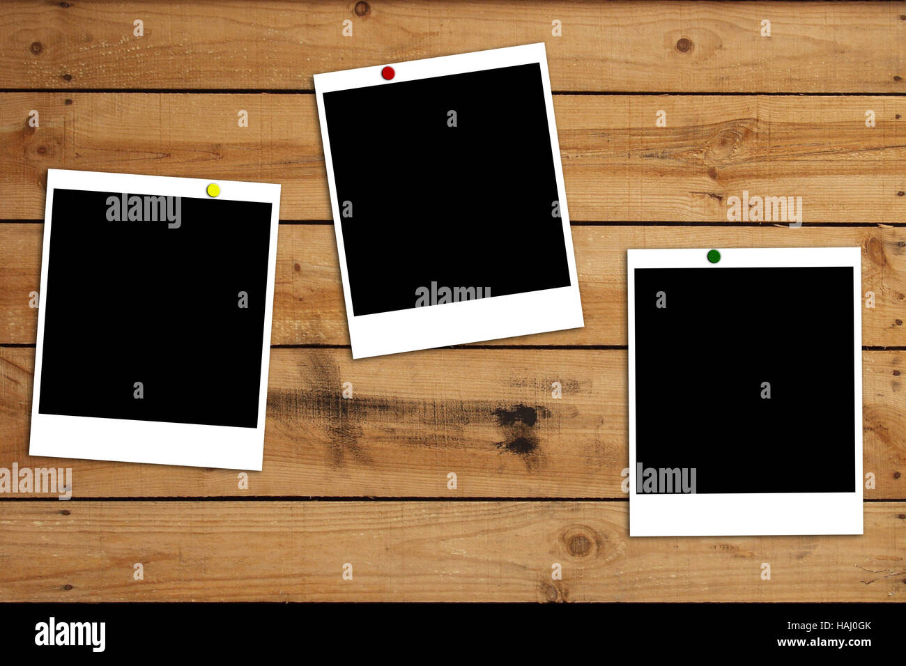 Blank photo frames on wooden plank background Stock Photo