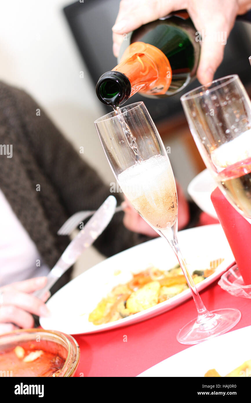 pouring champagne into a glass Stock Photo
