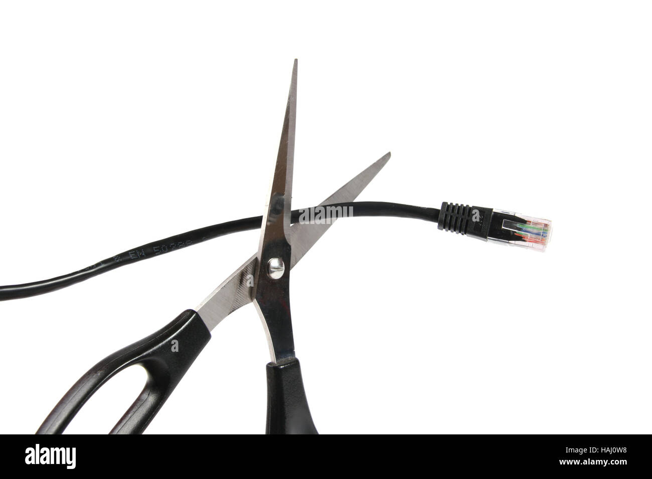 Scissors cutting a network cable Stock Photo