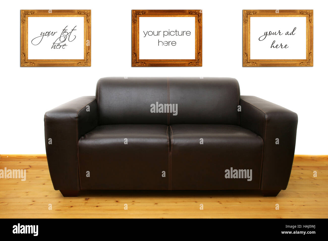 Brown leather sofa and blank photo frames on the wall Stock Photo