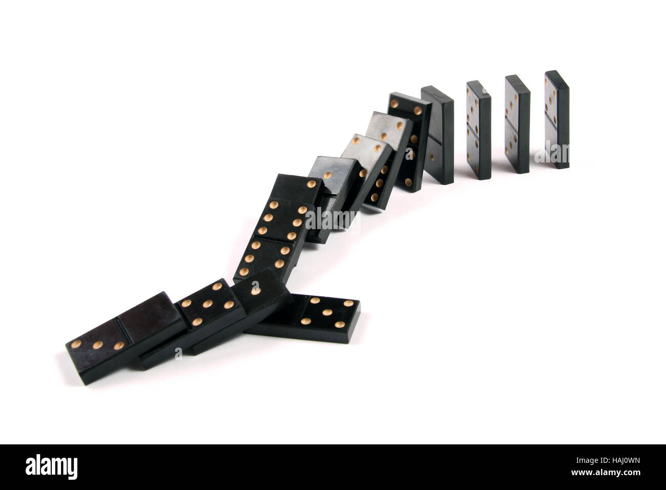 Stack of dominoes falling on white background Stock Photo