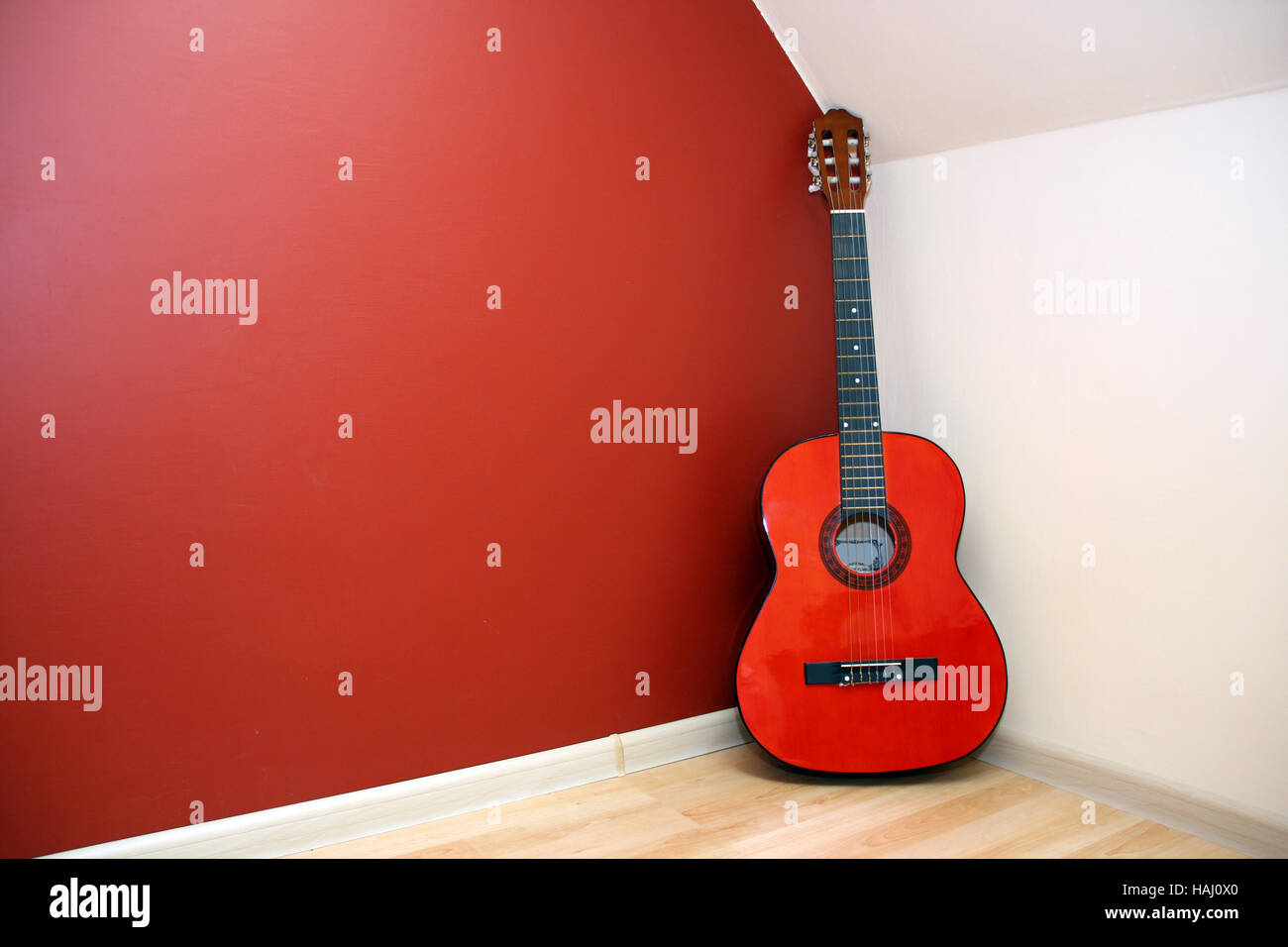 Acoustic guitar in room corner Stock Photo