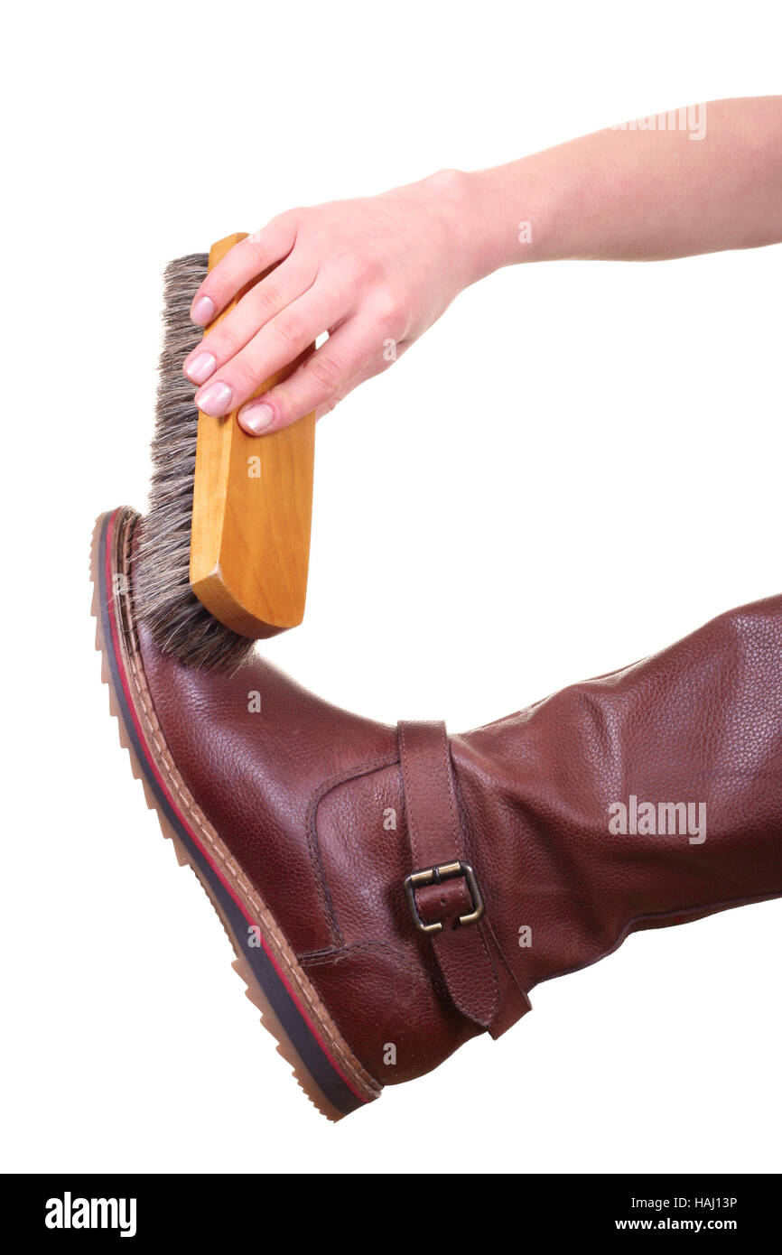 boot cleaning with brush isolated on white background Stock Photo