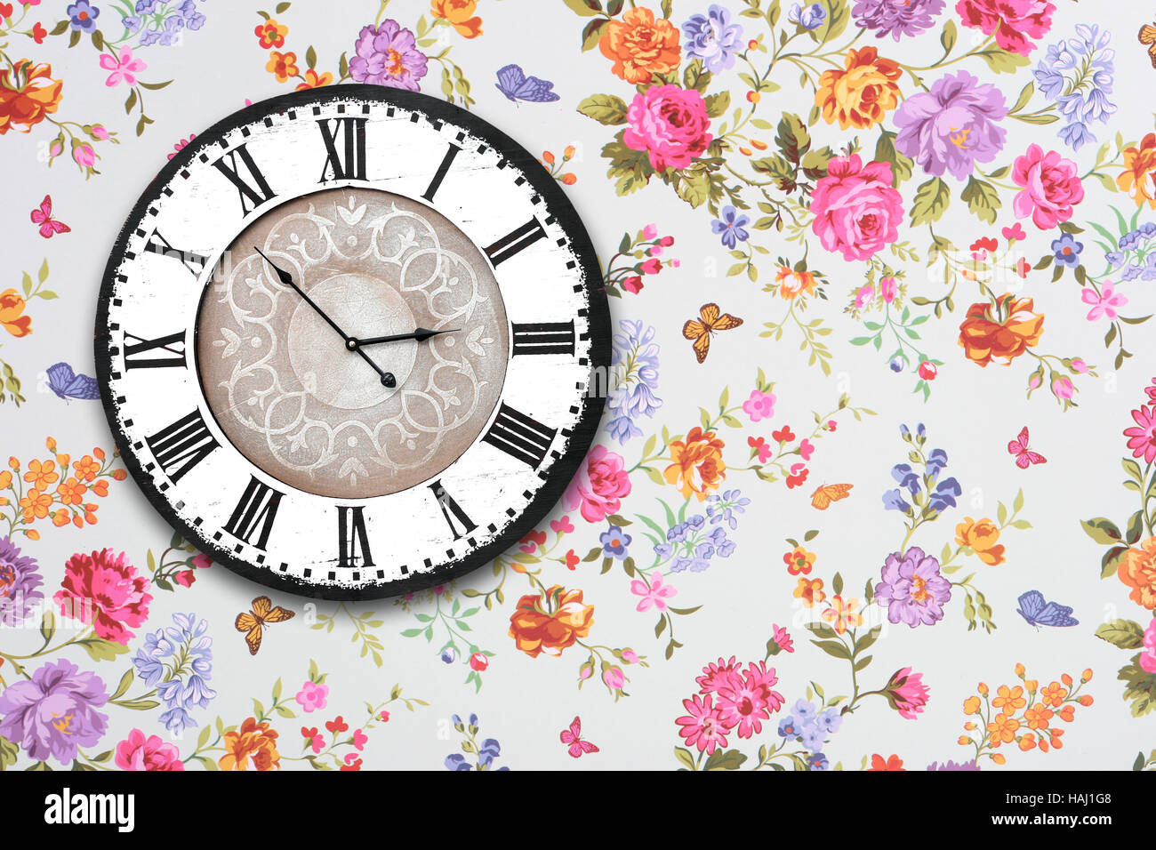 wooden retro clock on floral wallpaper Stock Photo - Alamy