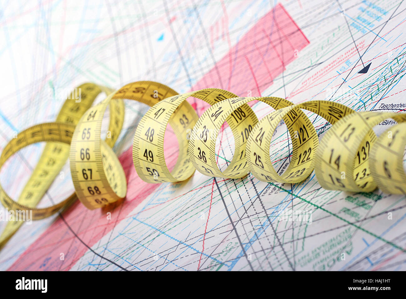 tailor measuring tape on patterns of clothing Stock Photo