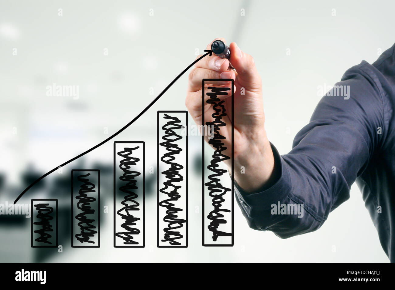 business man drawing a growing graph Stock Photo