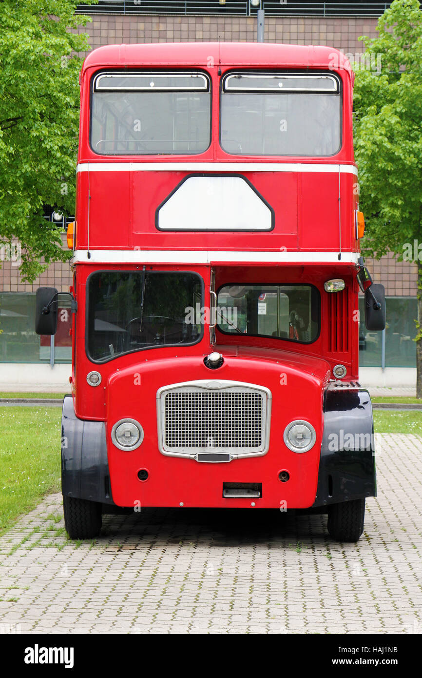 big red double decker bus on the street Stock Photo