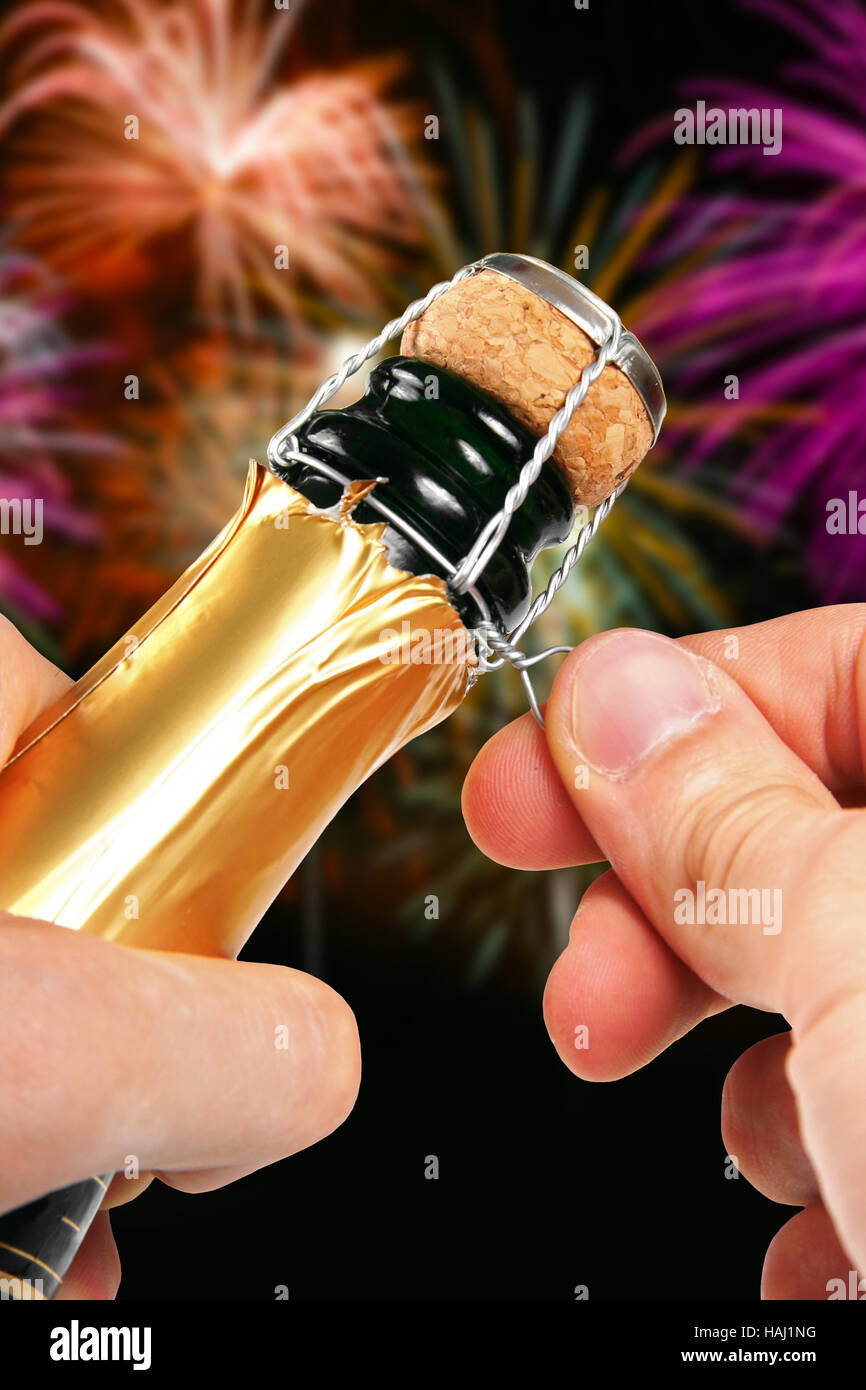 champagne opening with fireworks in the background Stock Photo