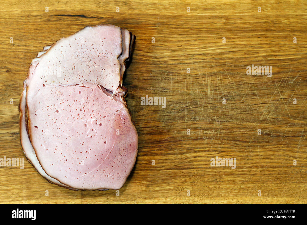 ham slices on wooden board Stock Photo