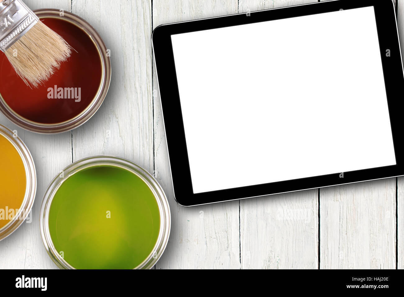 tablet with blank screen and colorful paint cans Stock Photo