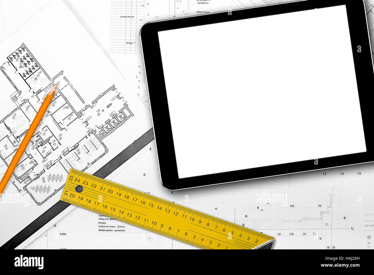 blank tablet and tools on house project blueprints Stock Photo