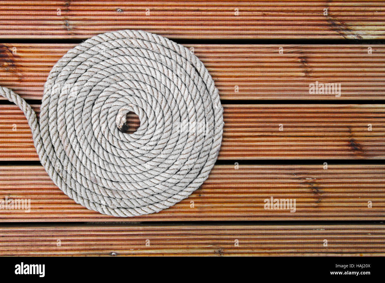 rope on wooden yacht deck Stock Photo