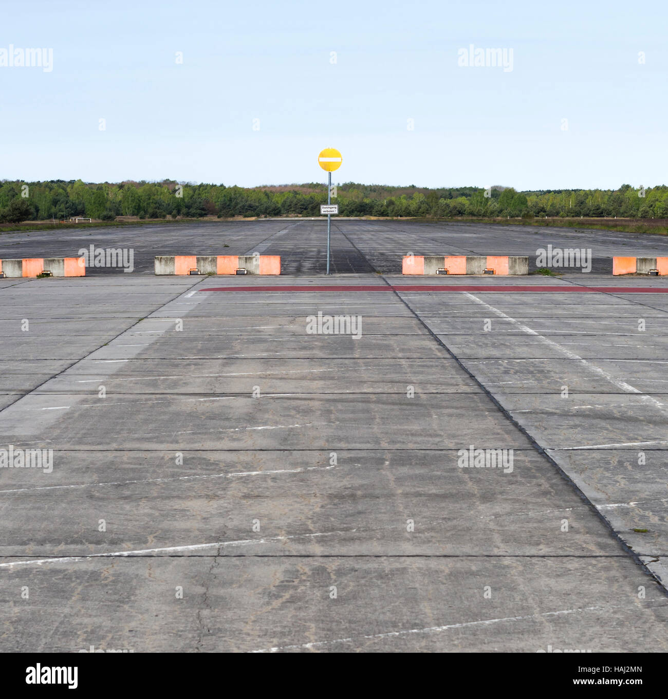 Abandoned concrete airport runway and blocked airfield Stock Photo