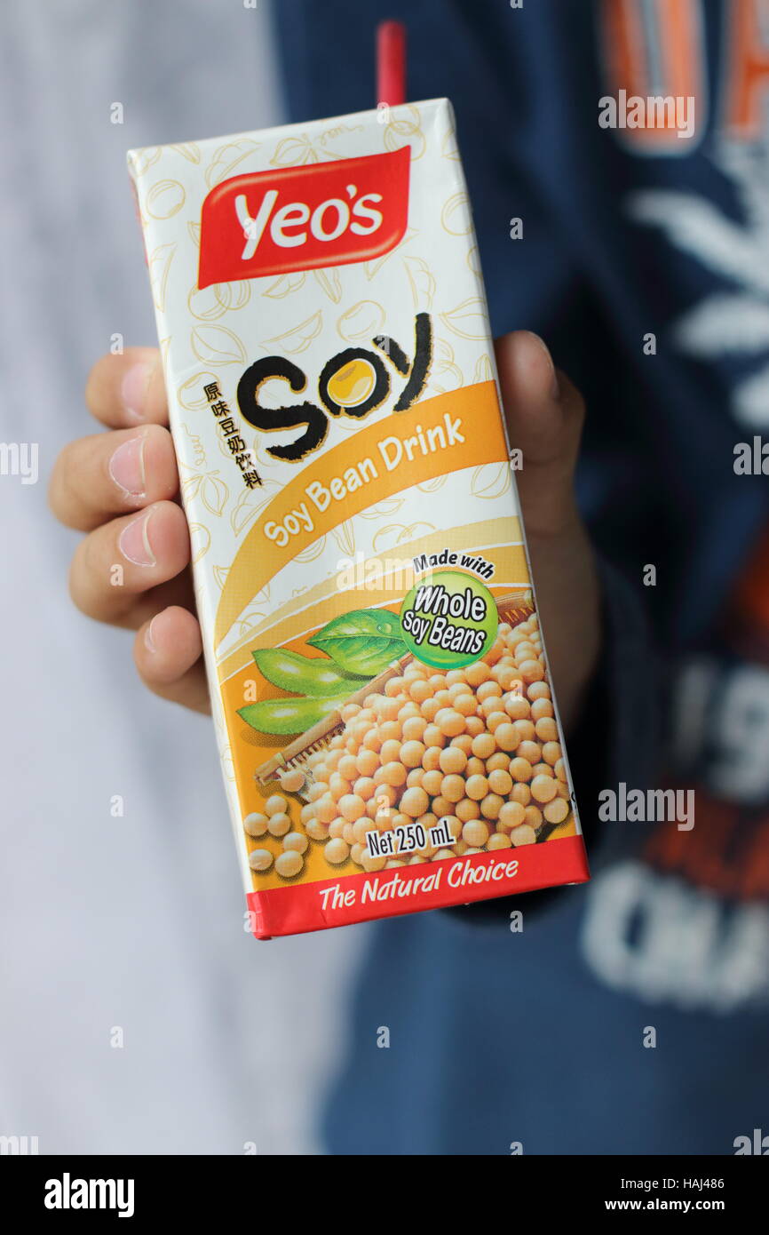 Close up of a child hand holding Yeo's Soy Bean drink Stock Photo
