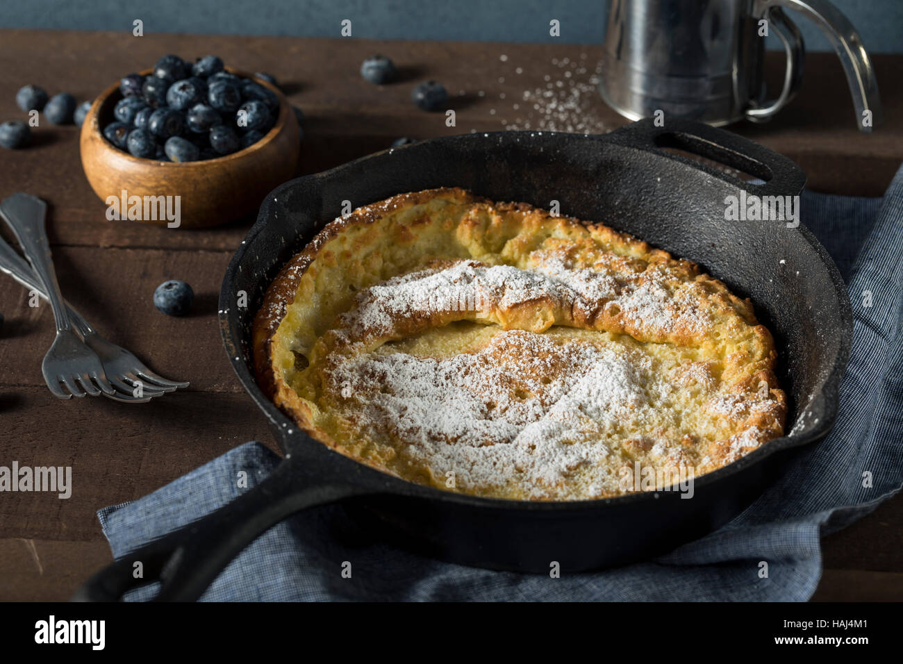Homemade Dutch Baby Pancake with Blueberries and Powdered Sugar Stock