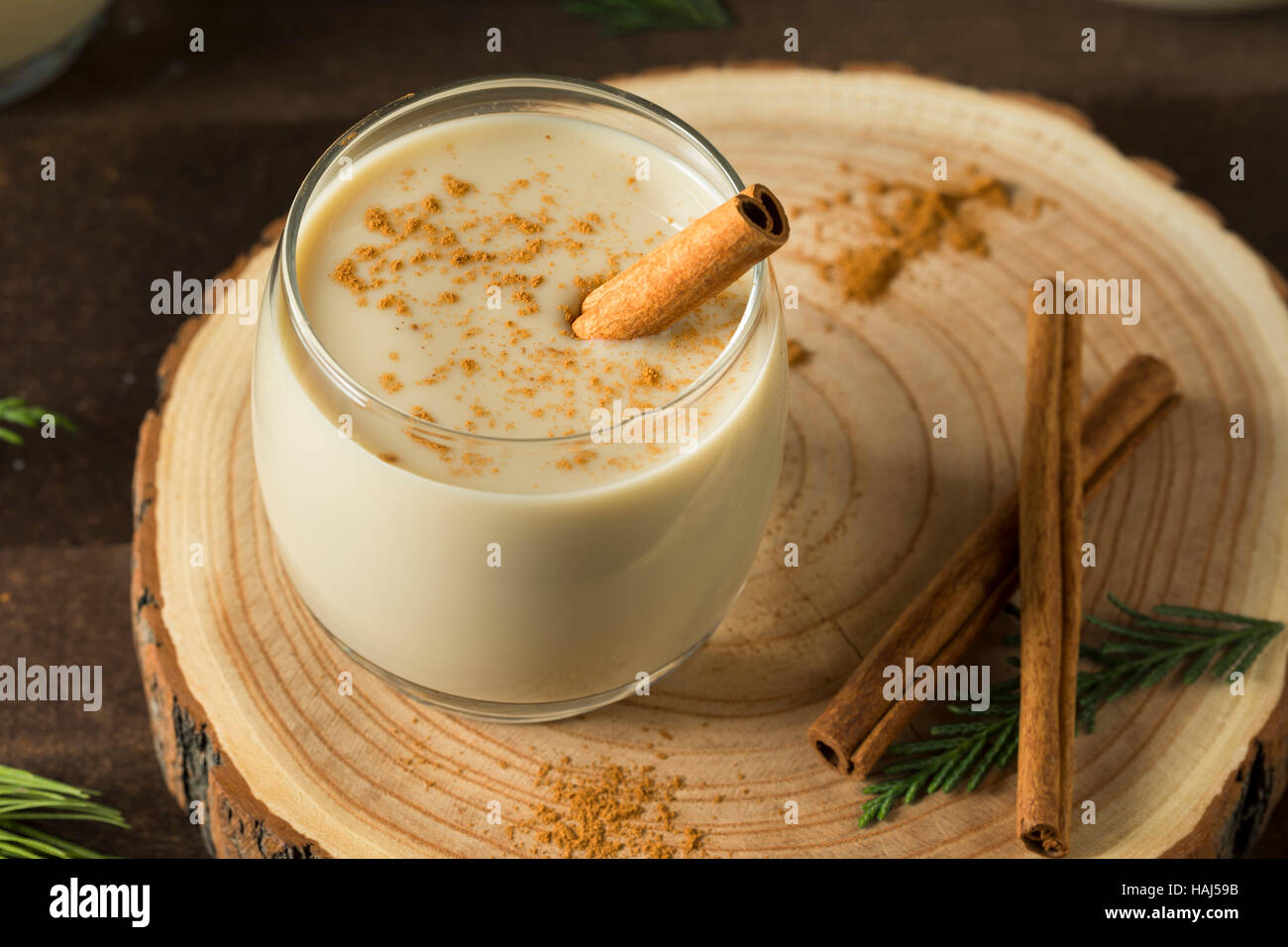 Eggnog with cinnamon and nutmeg for Christmas and winter holidays. Homemade  eggnog in glasses on wooden table surface, shallow depth of the field, cop  Stock Photo - Alamy