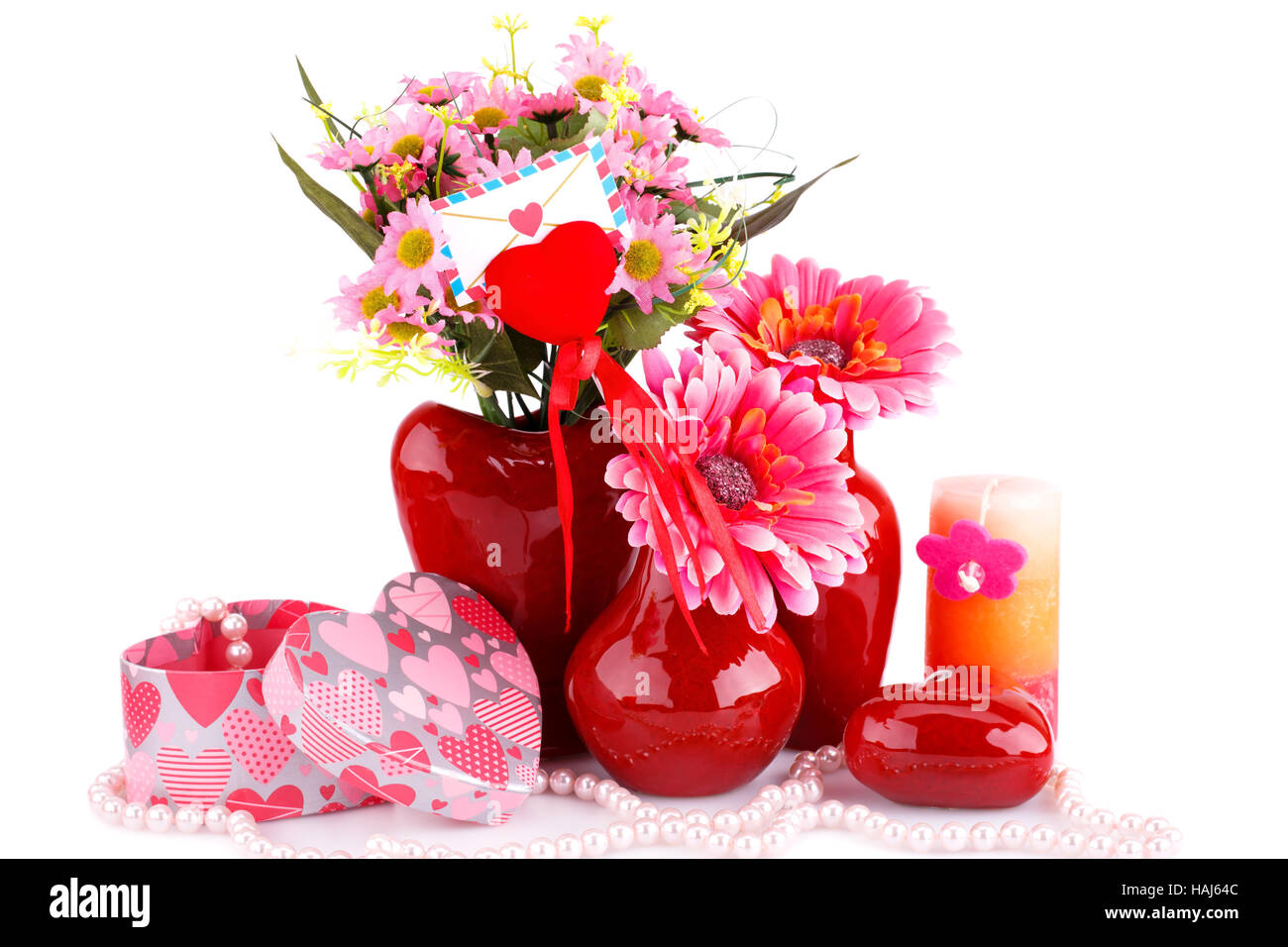 Flowers in vases, red heart glass, necklace, gift boxes and candle