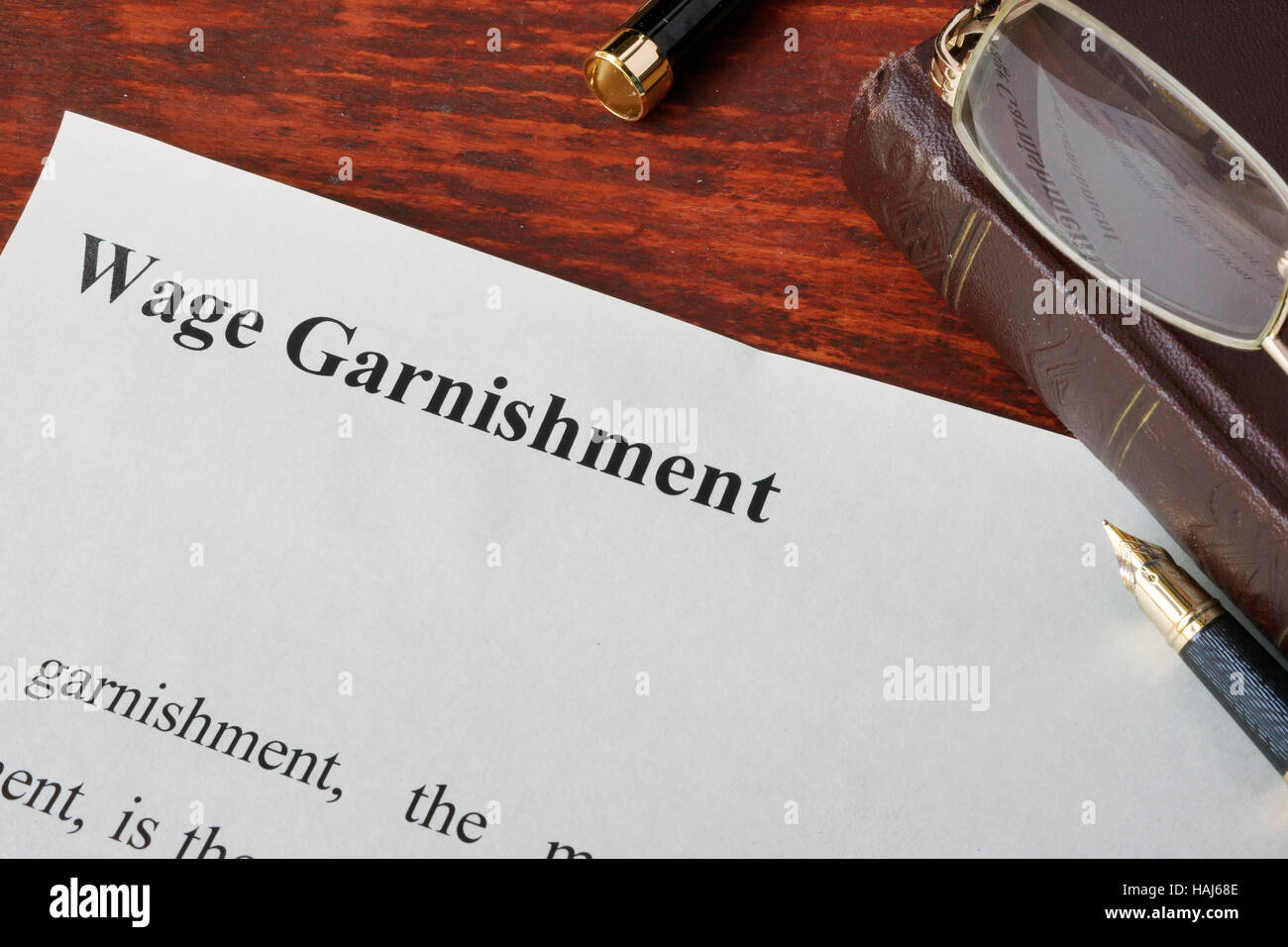 Wage Garnishment definition written on a paper. Stock Photo