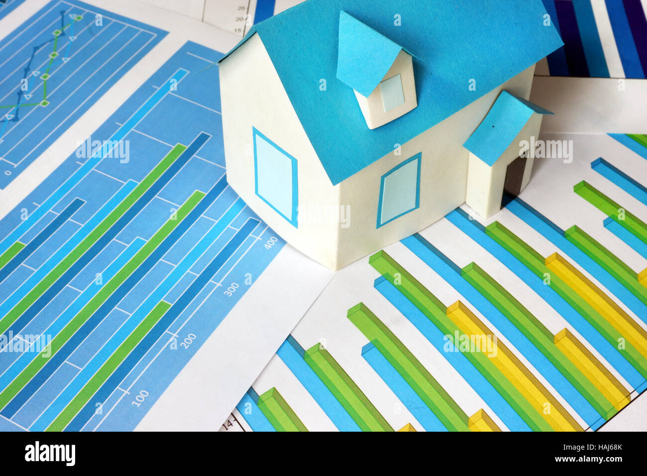 Charts and model of house. Real estate  concept. Stock Photo