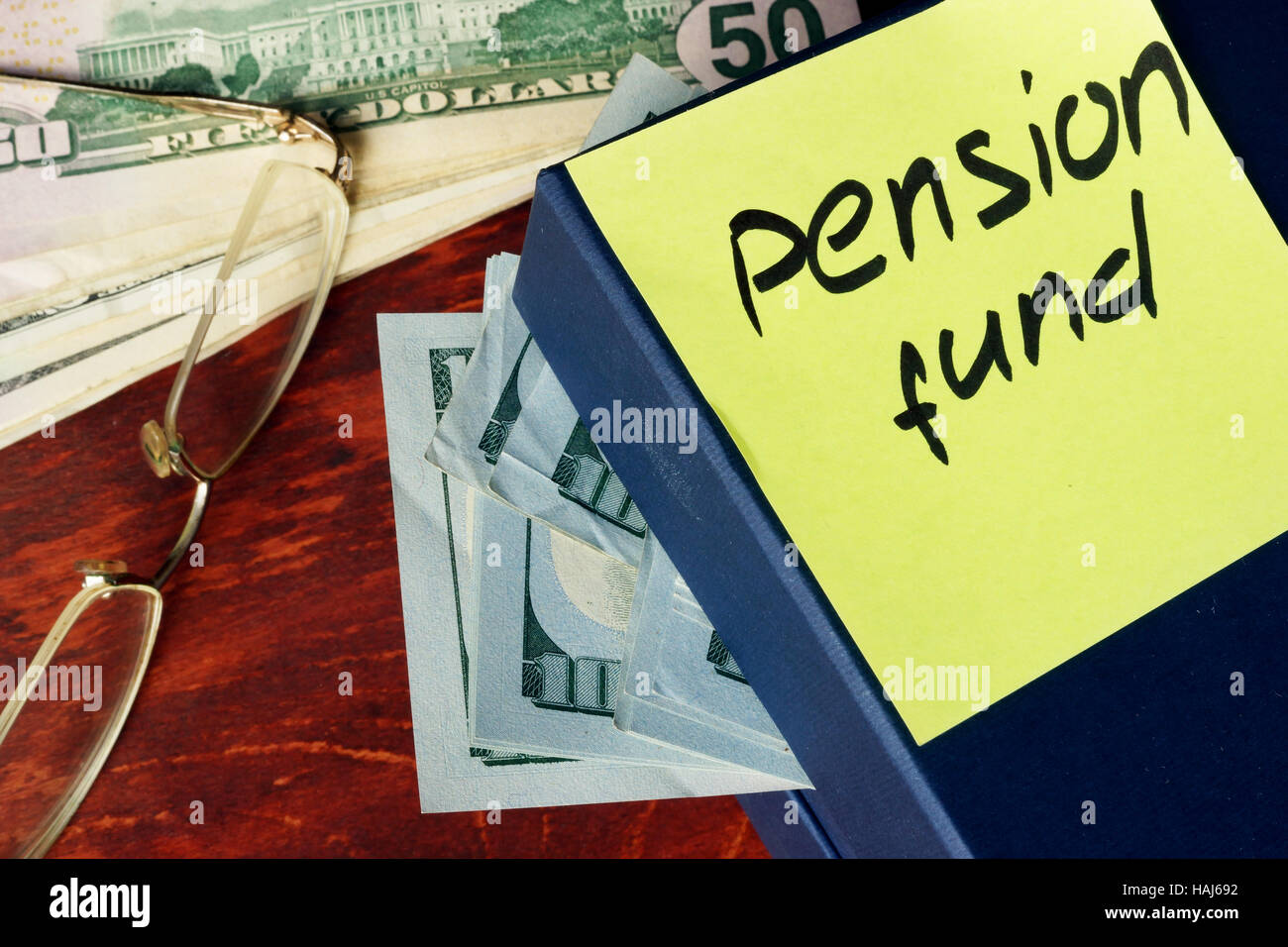 Pension fund concept. Box with cash and  sticker. Stock Photo