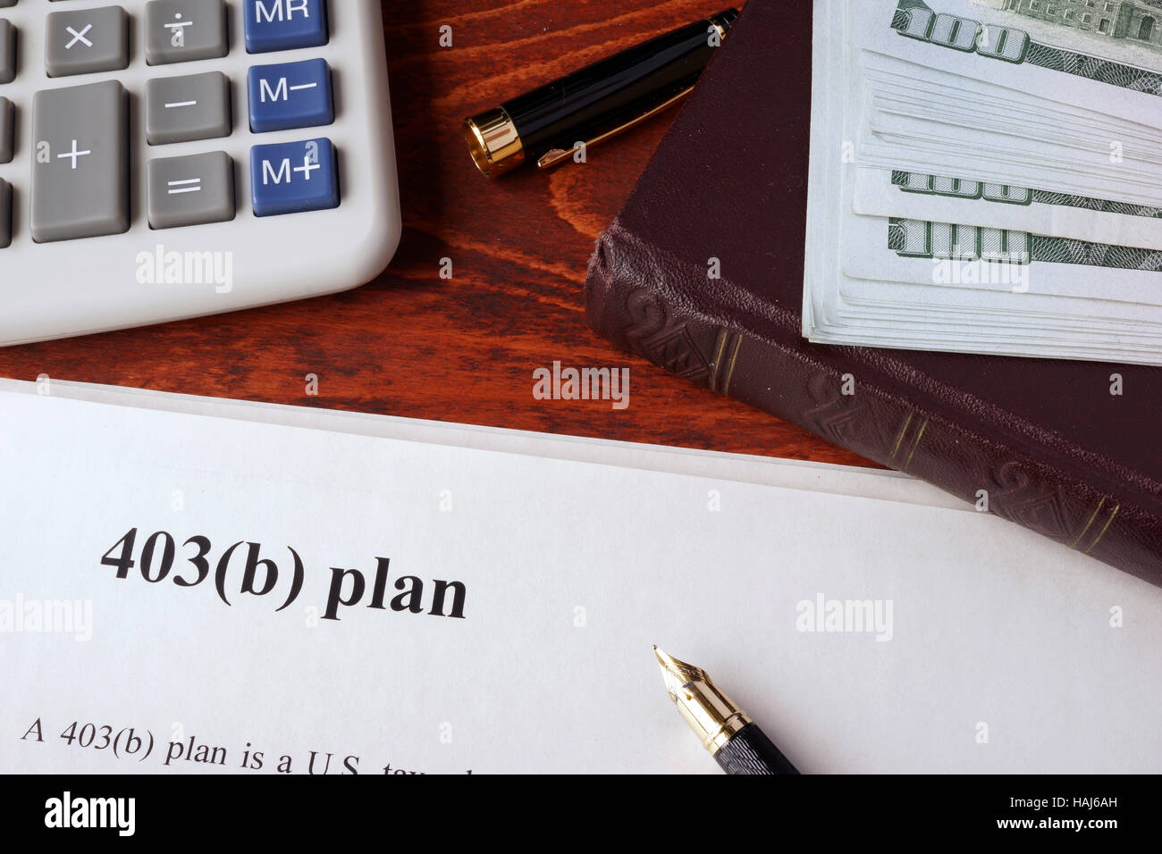 Papers with 403(b) Plan and book on a table. Stock Photo