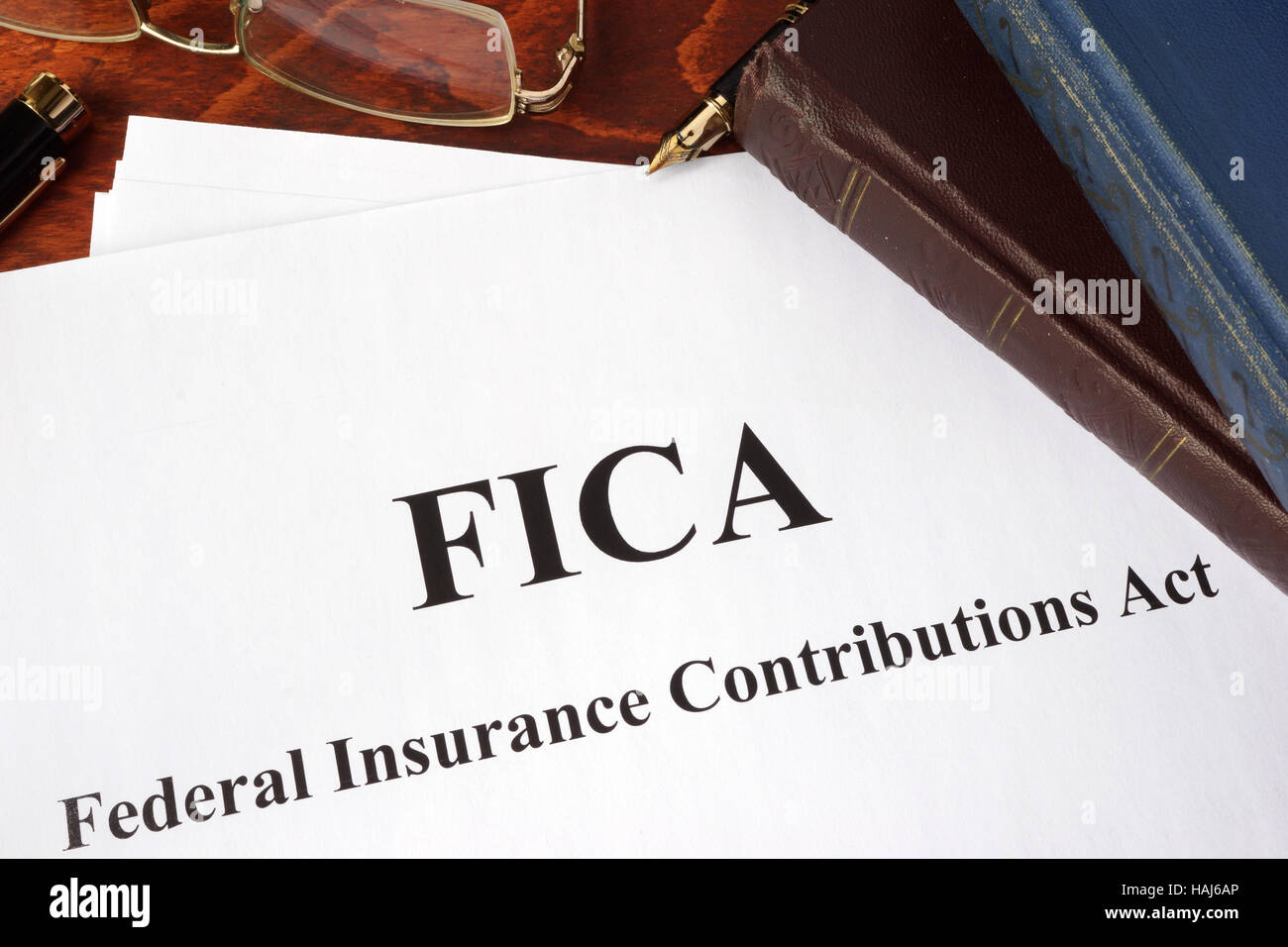 Papers with FICA Federal Insurance Contributions Act tax. Stock Photo