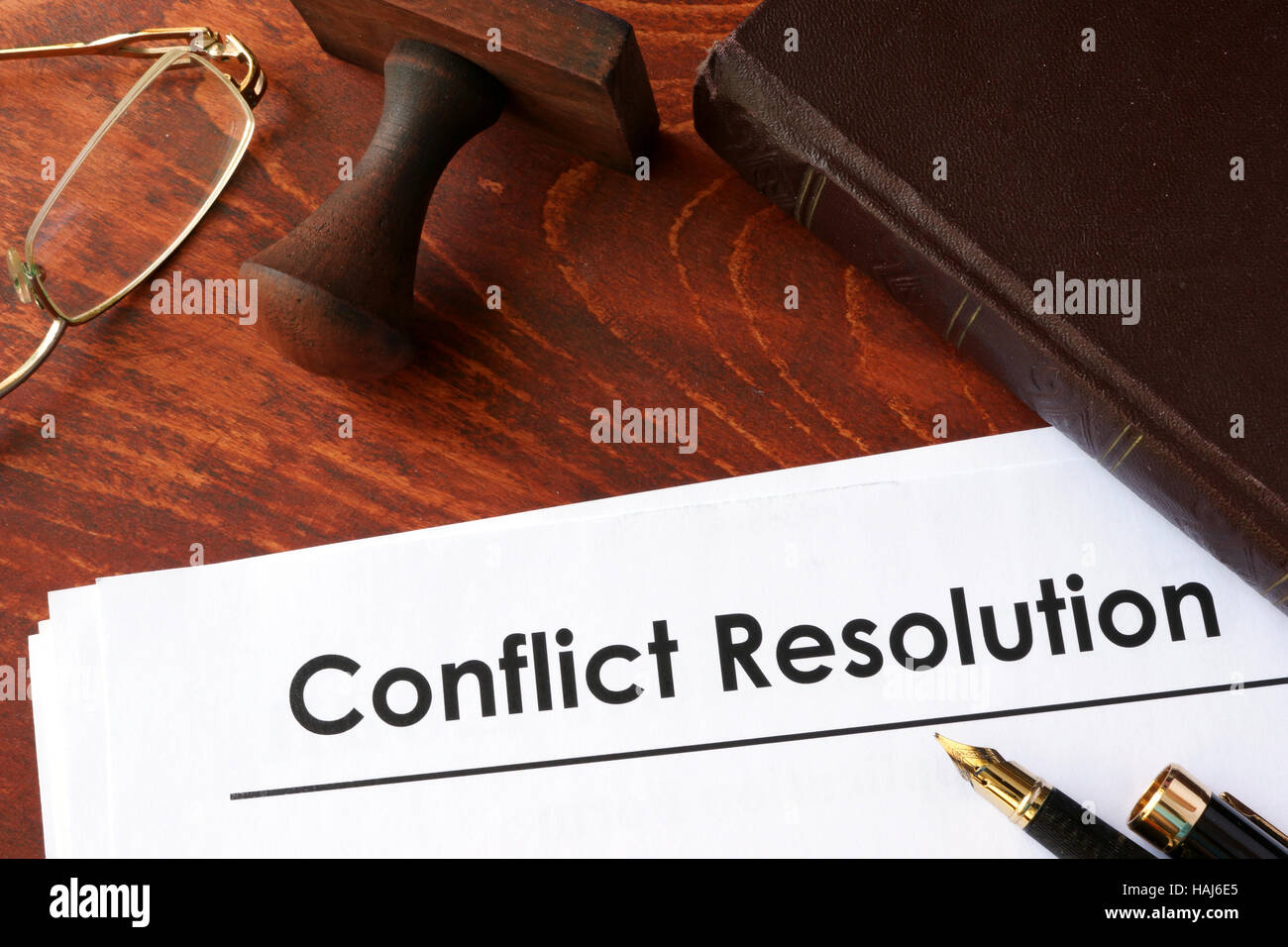 Papers with title conflict resolution on a table. Stock Photo