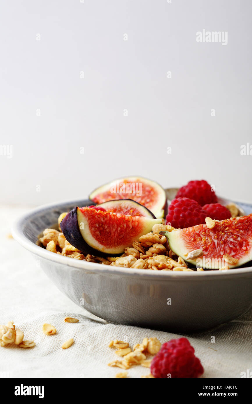 Muesli with figs and raspberry in bowl, food Stock Photo