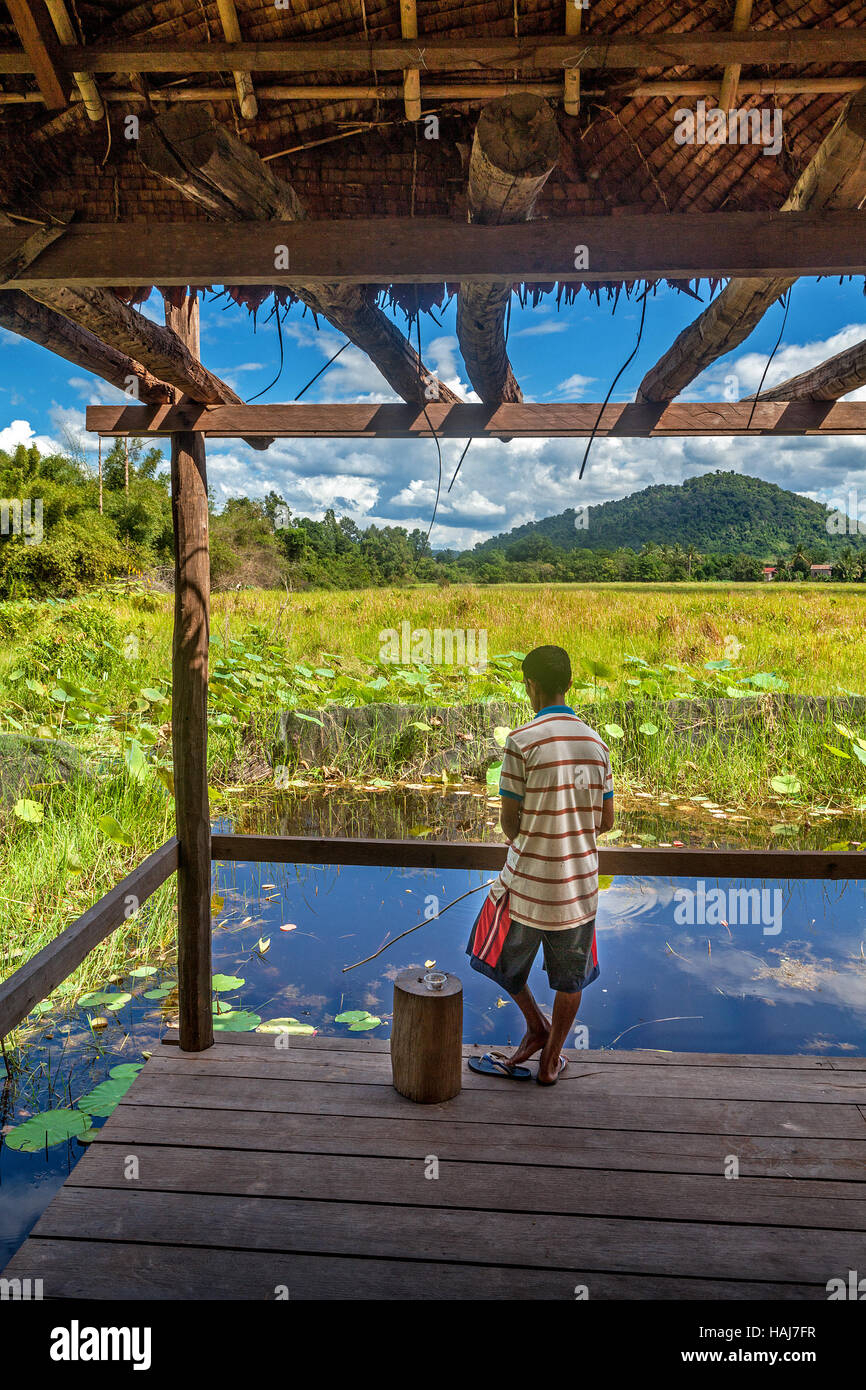 Life in the slow lane in Banteay Srei, Cambodia includes a day of casual fishing in the local pond with a lovely view. Stock Photo