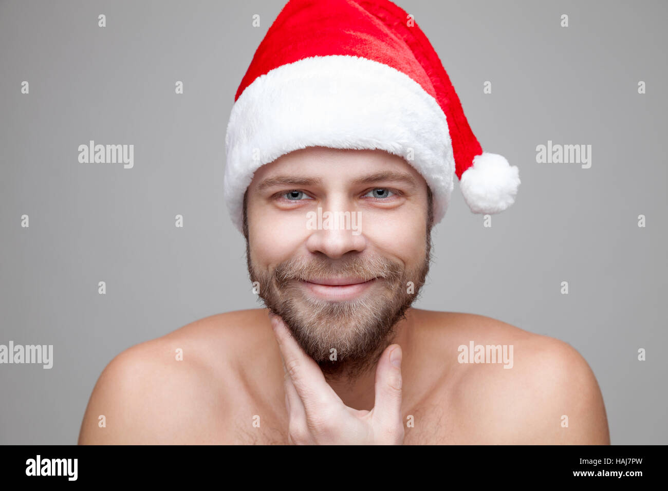Portrait of a handsome man with beard wearing a Christmas hat Stock Photo