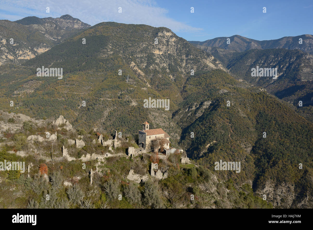 AERIAL VIEW. Isolated perched chapel in an abandoned hamlet high above the Tinée Valley. Tournefort, Alpes-Maritimes, France. Stock Photo