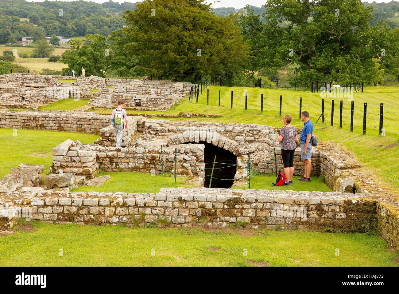 Tourists looking at Strongroom ruins. Chesters Roman Fort and Museum. Chollerford, Hexham, Northumberland, England, United Kingdom, Europe. Stock Photo