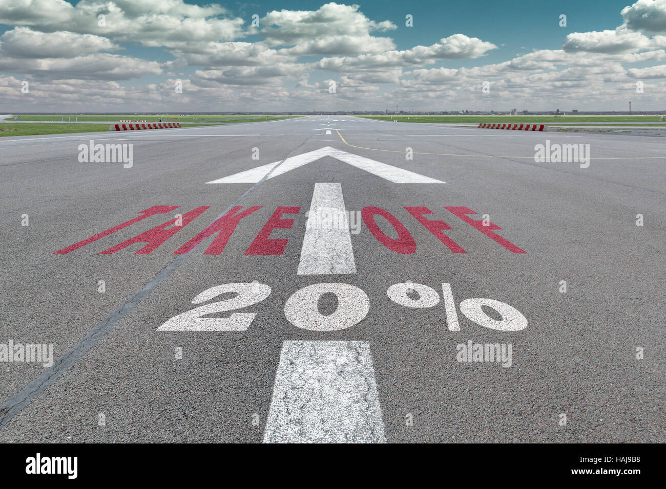 Runway of airport with arrow guideline, take off and 20 percent sign printed on the asphalt Stock Photo