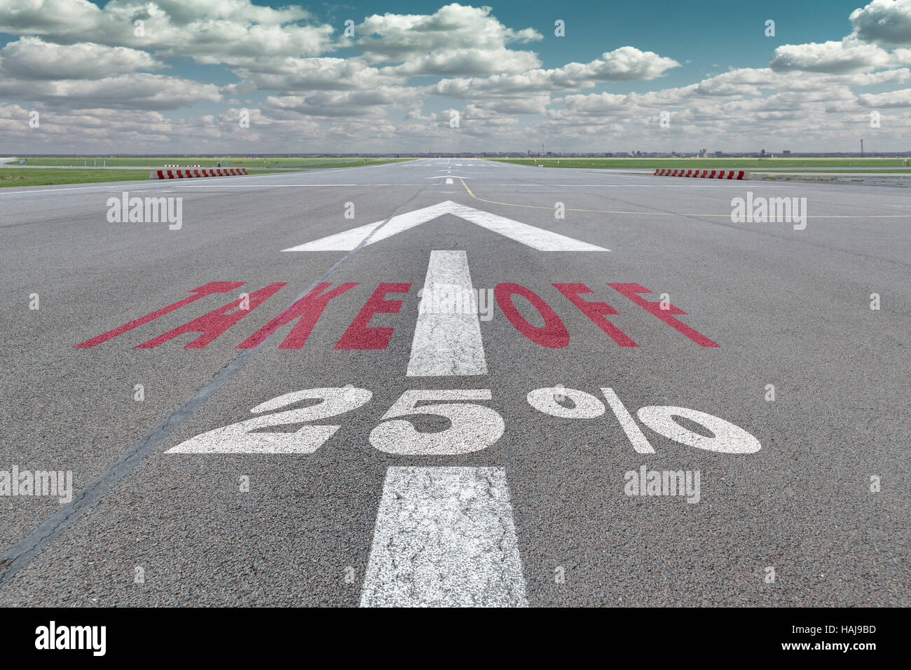 Runway of airport with arrow guideline, take off and 25 percent sign printed on the asphalt Stock Photo