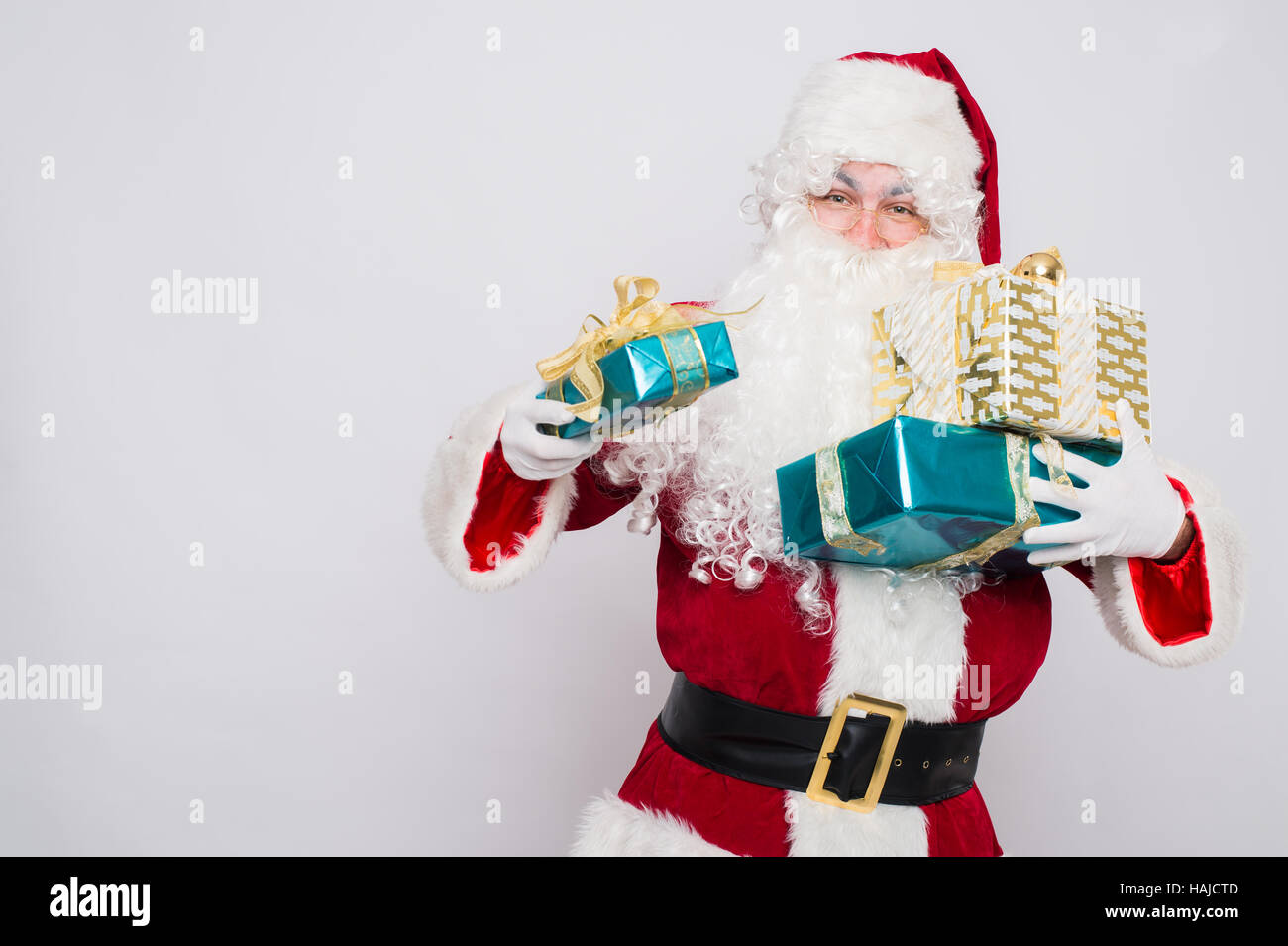 Santa Claus holding pile of gift boxes Closeup Portrait Stock Photo - Alamy