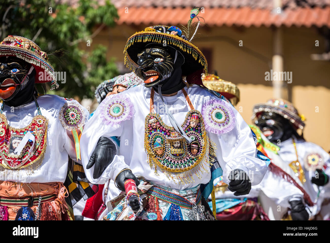 Men wearing colorful costumes during religious procession, Ollantaytambo, Cusco, Peru Stock Photo